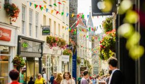 bustling image of people walking in front of shops